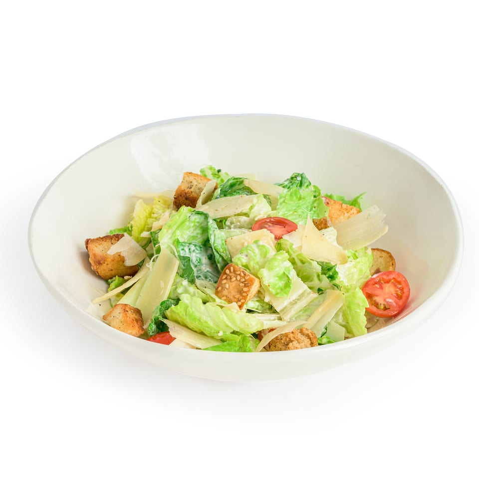 Alba's Pizzeria & Restaurant Caesar salad with romaine lettuce, croutons, parmesan, and cherry tomatoes.
